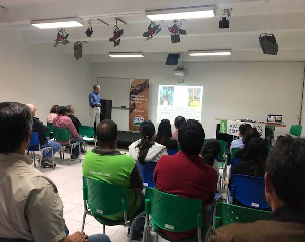 Participants at a seminar in Peru listen eagerly.